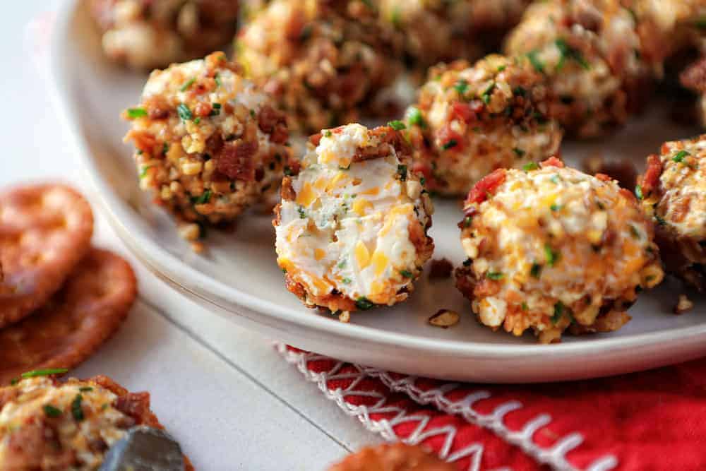 These perfect bite-sized cheese balls are a wonderful addition to your next get together! cheese ball, cheese ball bites, cheese ball recipe, iambaker Bacon Ranch Cheese Ball Bit Into Showing the Inside