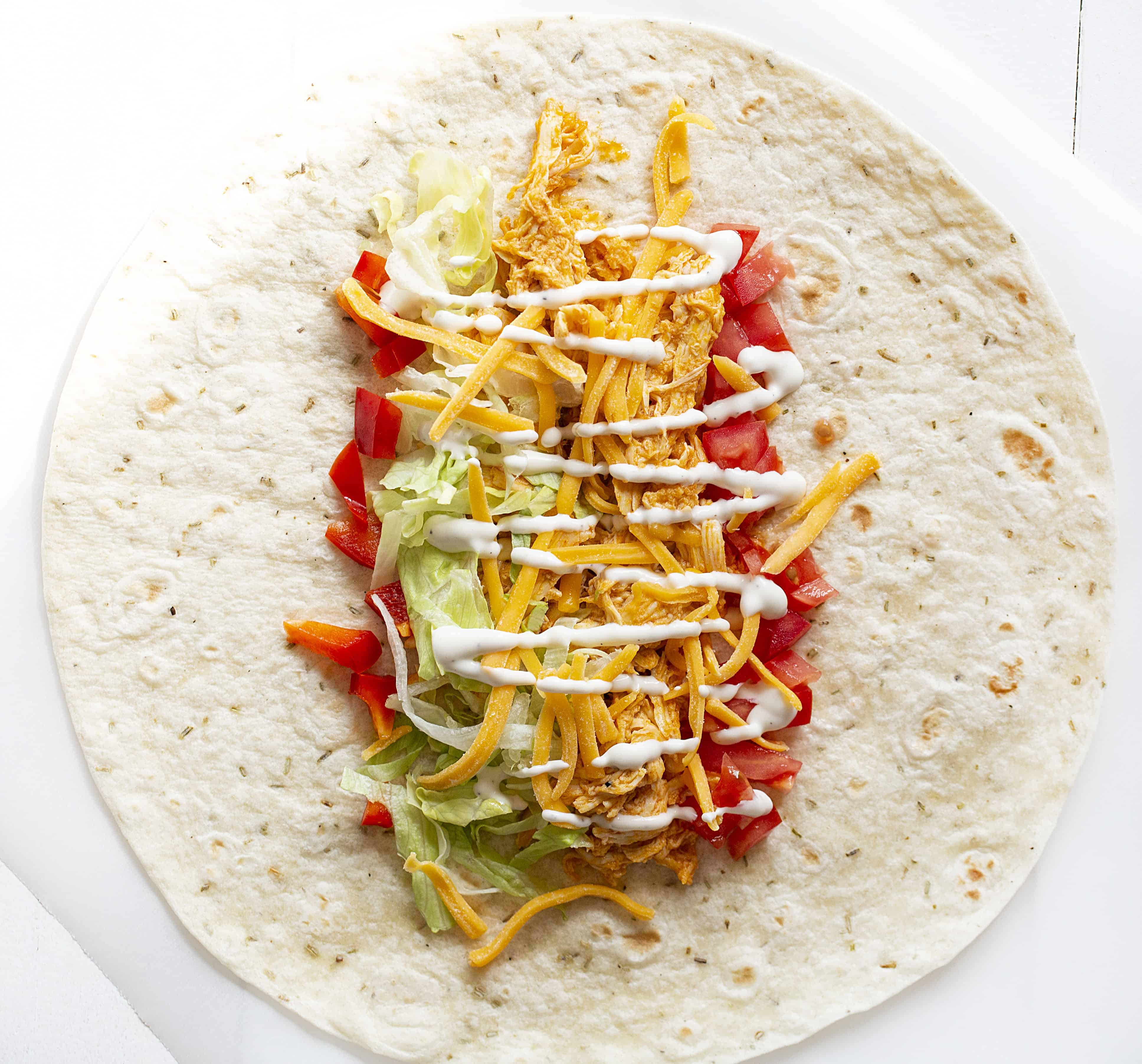Buffalo Chicken Wraps are a quick and easy lunch or dinner meal! buffalo sauce, buffalo chicken, buffalo chicken wraps, wrap recipes, chicken wraps, rotisserie chicken, chicken recipes, iambaker Buffalo Chicken Recipes