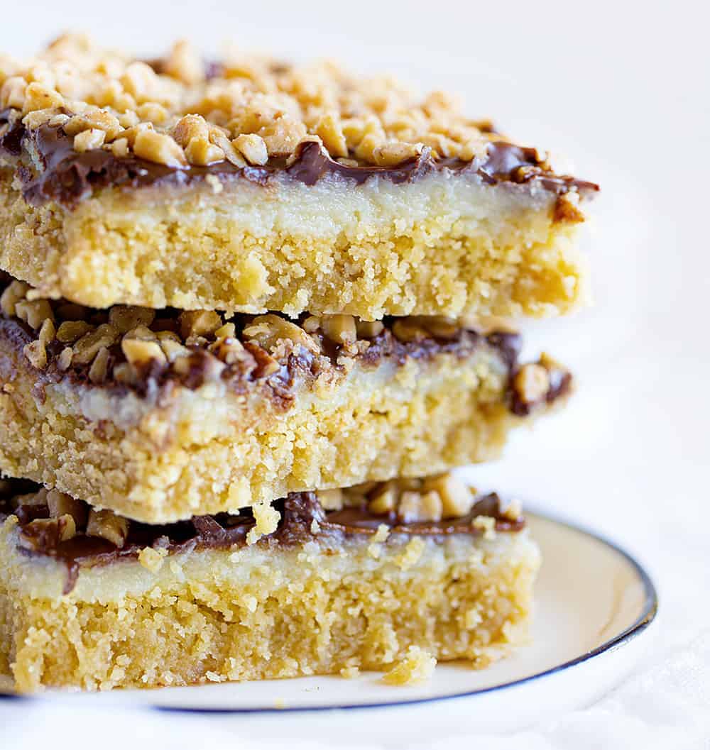 Chocolate Toffee Bars are a gooey delight with layers of flavor and satisfaction! iambaker, chocolate toffee bar, baking, desserts, chocolate toffee, toffee, dessert bars Chocolate Toffee Bar Stacked Three High