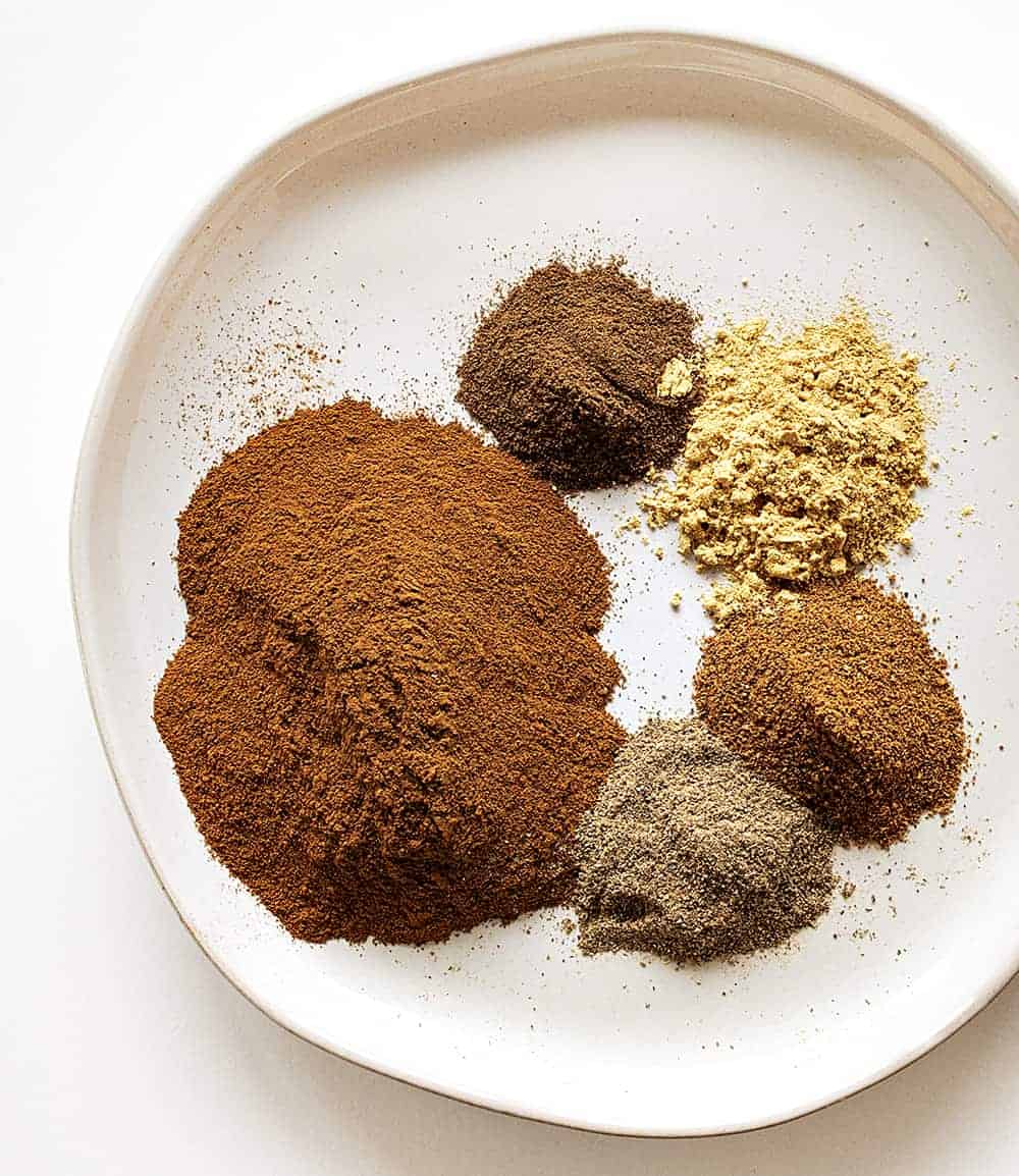 Homemade Apple Pie Spice is a spice that is a must for your fall and winter recipes! homemade apple pie spice, apple pie spice, apple spice, iambaker, homemade spices, baking, apples, apple pie Ingredients for Homemade Apple Pie Spice on a Plate.
