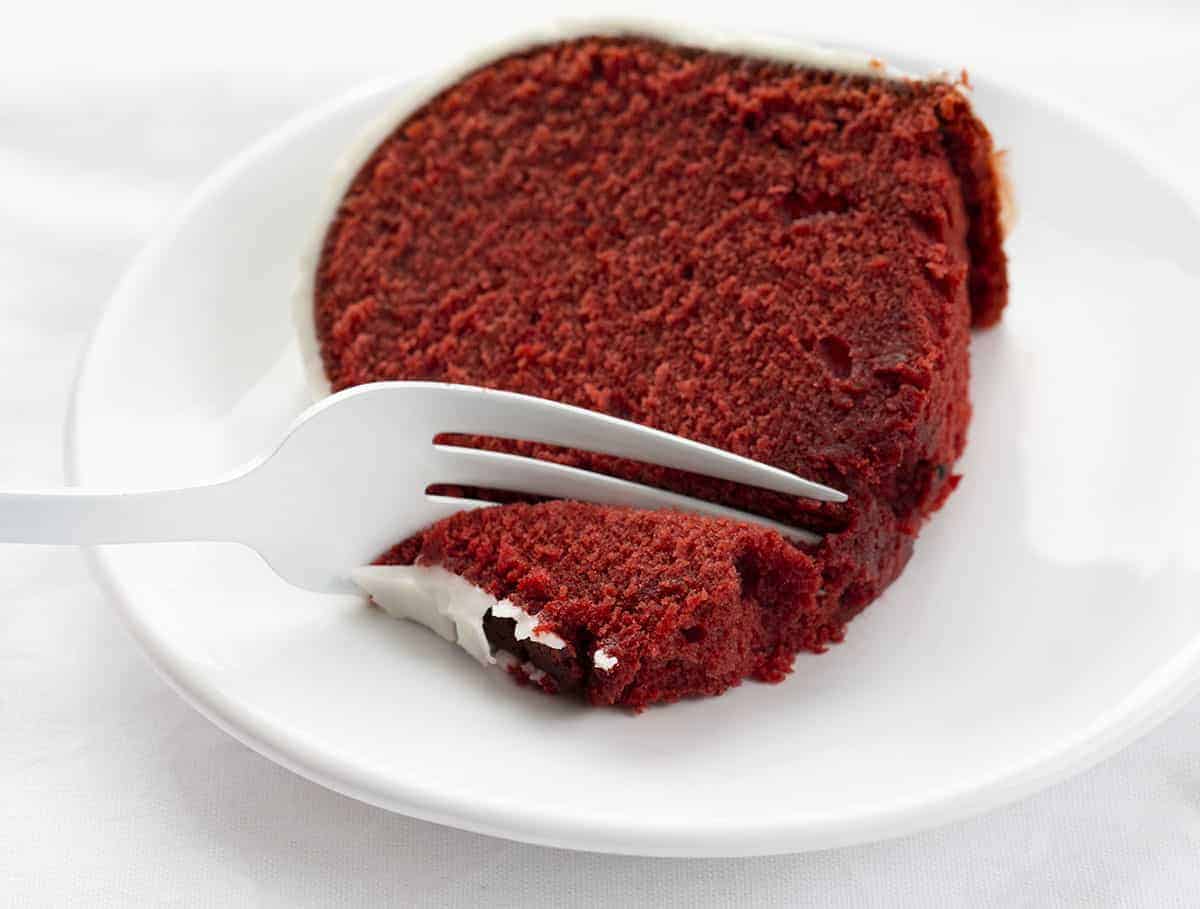 Red Velvet Pound Cake is a delicate, yet dense, cake that has a slight, but not too sweet chocolate flavor with a cream cheese frosting as the icing on the cake, literally! Red Velvet Cake, Red Velvet Pound Cake, Cream Cheese Frosting, Moist Red Velvet Cake, Bundt Cake, Pound Cake, Red Velvet, Baking, Recipes, Dessert, Red Velvet, i am baker, iambaker Fork Taking Bite of Red Velvet Pound Cake