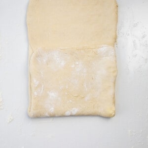 Folding OVer Dough to Laminate to Make Cruffins.