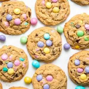 Looking down on Easter Monster Cookies with pastel M&M's on a white table.